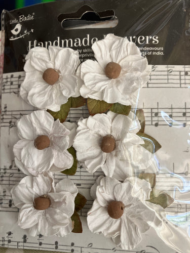 White paper flowers with a bead centre